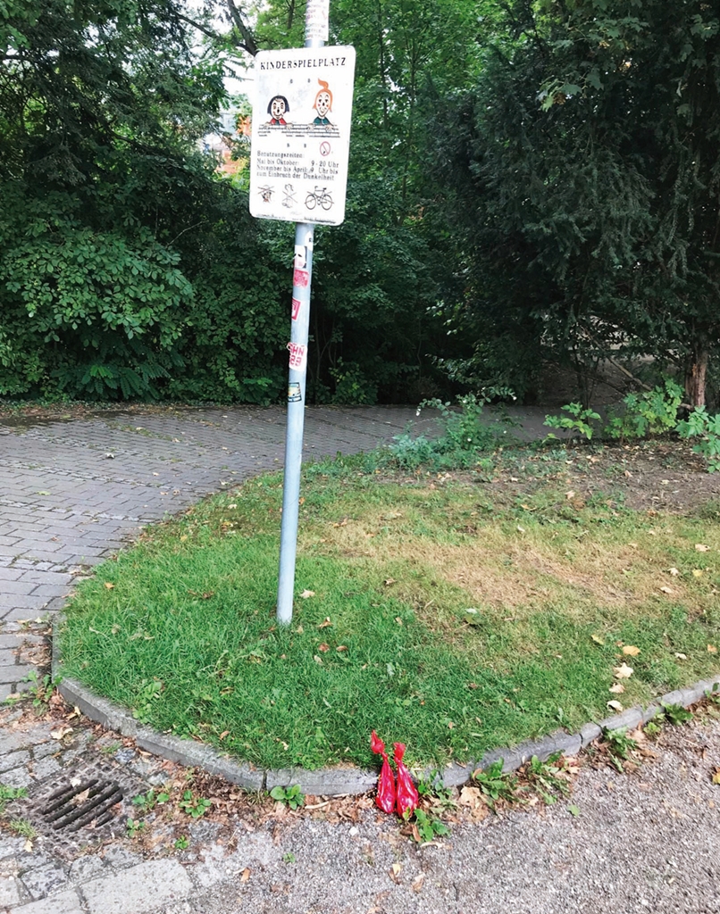 Von einem superdämlichen Hundebesitzer an einem Spielplatzeingang liebevoll hindrapierte Hundekotbeutel.