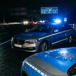 Firefly_Gemini Flash_German police car in blue and silver livery parked on the hard shoulder of a German a 214330