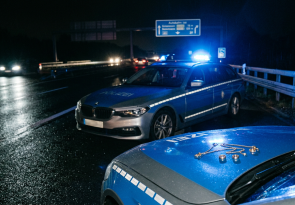 Firefly_Gemini Flash_German police car in blue and silver livery parked on the hard shoulder of a German a 214330