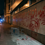 Firefly_Gemini Flash_Night scene in a German city street, the long plain wall of a commercial building fre 214330